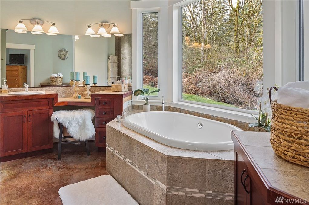 freshly painted sage green bathroom with soaking tub and cherry wood vanity in Cranberry Township, PA