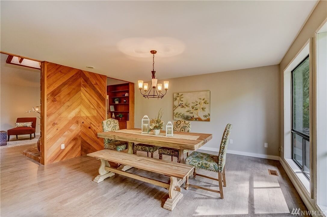 freshly painted dining room with wooden herringbone accent wall and chandelier in Cranberry Township, PA